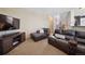 Comfortable living room with plush seating, modern TV console, and neutral decor at 9684 W Long Dr, Littleton, CO 80123