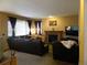 Cozy living room with fireplace, comfortable seating, and natural light at 9684 W Long Dr, Littleton, CO 80123
