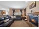 Cozy living room features a brick fireplace and a large window for natural light at 9684 W Long Dr, Littleton, CO 80123