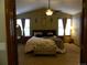 Spacious bedroom with vaulted ceiling, plush carpet, neutral paint, ceiling fan and two windows offering natural light at 9684 W Long Dr, Littleton, CO 80123