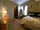 Bedroom featuring a double door closet, plush carpet, neutral paint colors, and two windows providing natural light at 9684 W Long Dr, Littleton, CO 80123