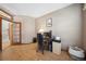Home office with ample natural light, built-in desk, and wood flooring at 9684 W Long Dr, Littleton, CO 80123
