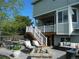 Back patio with outdoor seating, fire pit, and well-manicured yard, perfect for outdoor entertaining and relaxation at 9684 W Long Dr, Littleton, CO 80123