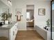 Bright bathroom with double vanity, a soaking tub, and a view into the bedroom at 4090 Estrella St, Brighton, CO 80601