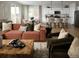 Open-concept living room with a sectional sofa, modern furnishings, and access to the kitchen and dining area at 4090 Estrella St, Brighton, CO 80601