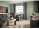 Cozy living room with comfortable seating, a large window, and a wall-mounted television at 4090 Estrella St, Brighton, CO 80601