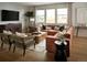 Well-lit living room featuring an L-shaped couch, a wooden coffee table, and large windows at 4090 Estrella St, Brighton, CO 80601