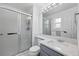 Well-lit bathroom with a sliding glass door shower and modern fixtures at 11041 Newland St, Westminster, CO 80020