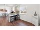 Well-lit kitchen with a breakfast bar, granite countertops, and seamless access to the dining area at 11041 Newland St, Westminster, CO 80020