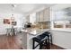 Well-lit kitchen with a breakfast bar, granite countertops, and seamless access to the dining area at 11041 Newland St, Westminster, CO 80020
