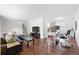 Bright living room with hardwood floors, an office area, and seamless connection to the kitchen at 11041 Newland St, Westminster, CO 80020