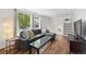 Bright living room with hardwood floors and a large window offering a pleasant view of the outdoors at 11041 Newland St, Westminster, CO 80020
