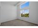 Bright and airy bedroom features a large window with scenic views, neutral carpet and clean white walls at 8711 E Hampden Ave # 6, Denver, CO 80231