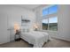 Airy bedroom featuring large windows, neutral walls and carpet, and a simple bed frame at 8711 E Hampden Ave # 6, Denver, CO 80231