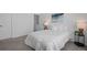 Bright bedroom featuring neutral walls and carpet and a simple bed frame with white linen at 8711 E Hampden Ave # 6, Denver, CO 80231