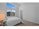 Bright bedroom featuring large windows, neutral walls and carpet, and a simple bed frame at 8711 E Hampden Ave # 6, Denver, CO 80231