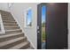 Entryway featuring a modern front door, window, and carpeted stairs leading to upper level at 8711 E Hampden Ave # 6, Denver, CO 80231
