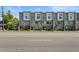 Contemporary townhome exterior showcasing modern architecture with multiple windows and professionally landscaped frontage at 8711 E Hampden Ave # 6, Denver, CO 80231