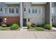 Modern townhome exterior highlighting clean lines, multiple windows, and tidy landscaping along a sidewalk at 8711 E Hampden Ave # 6, Denver, CO 80231
