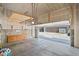 Clean, open garage with storage platform and work area at 8711 E Hampden Ave # 6, Denver, CO 80231
