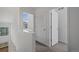 Bright upstairs hallway leading to bedrooms, featuring modern doors, neutral colors, and ample natural light at 8711 E Hampden Ave # 6, Denver, CO 80231