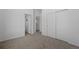 Upstairs hallway with modern doors, neutral colors, and access to closet and bathroom at 8711 E Hampden Ave # 6, Denver, CO 80231