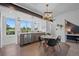 Modern kitchen featuring stainless steel appliances, granite countertops, bright windows, and an adjacent dining area at 8711 E Hampden Ave # 6, Denver, CO 80231