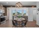 Modern eat-in kitchen with stainless steel appliances, wooden cabinets, and a charming breakfast nook with backyard views at 8711 E Hampden Ave # 6, Denver, CO 80231