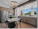 Eat in kitchen featuring stainless steel appliances, bright windows, and an adjacent dining area at 8711 E Hampden Ave # 6, Denver, CO 80231