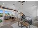 Open-concept living space includes a modern kitchen, dining area, and comfortable seating with stairs in the background at 8711 E Hampden Ave # 6, Denver, CO 80231