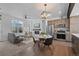 Open-concept living area with combined living, dining, and kitchen spaces, showcasing modern design and natural light at 8711 E Hampden Ave # 6, Denver, CO 80231
