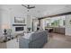 Inviting living room boasts a cozy fireplace, stylish furniture, and seamless flow into the adjacent kitchen and dining area at 8711 E Hampden Ave # 6, Denver, CO 80231