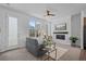 Inviting living room with a cozy fireplace, large window, neutral carpeting, and stylish furnishings at 8711 E Hampden Ave # 6, Denver, CO 80231