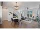 Bright living room with modern decor, hardwood floors, dining area, and an open floor plan at 8711 E Hampden Ave # 6, Denver, CO 80231