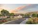 Arcadian community entrance featuring a stylish gate, modern fencing, landscaping, and mountain views at 5052 Nile Ct, Golden, CO 80403