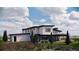 Modern home with clean lines, large windows, and covered patio in a natural setting at 5052 Nile Ct, Golden, CO 80403