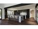Spacious kitchen with modern appliances, large island, dark cabinetry, and stylish lighting at 5052 Nile Ct, Golden, CO 80403