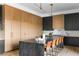 Contemporary kitchen with a large center island, modern appliances, and stylish wood and dark cabinets at 5052 Nile Ct, Golden, CO 80403