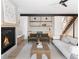 Inviting living room with a fireplace, a wet bar, comfortable seating, and natural light at 5052 Nile Ct, Golden, CO 80403