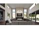 Elegant living room with fireplace, floor-to-ceiling windows, and comfortable seating at 5052 Nile Ct, Golden, CO 80403
