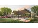 Outdoor seating area features a pergola with shade, dining tables, fire pit, and views of the community at 5052 Nile Ct, Golden, CO 80403