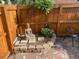 Cozy backyard space featuring a Buddha statue, brick pavers, and a wooden fence with decorative elements at 1038 E 4Th Ave, Denver, CO 80218