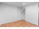 Finished basement area with LVP floors and staircase and fresh, neutral color palette at 1038 E 4Th Ave, Denver, CO 80218
