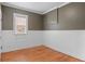 Bedroom featuring hardwood floors, chair railing, and large window at 1038 E 4Th Ave, Denver, CO 80218
