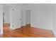 Bright bedroom featuring gleaming hardwood floors, white walls, and several doorways at 1038 E 4Th Ave, Denver, CO 80218