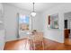 Cozy dining area with wood floors, glass table, and a pass-through to the kitchen at 1038 E 4Th Ave, Denver, CO 80218