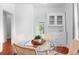 Bright dining area featuring a glass table, seating for four, and a built-in cabinet at 1038 E 4Th Ave, Denver, CO 80218