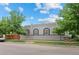 Home exterior with mature trees, showcasing the property's inviting curb appeal and serene surroundings at 1038 E 4Th Ave, Denver, CO 80218