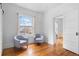 Bright living room with hardwood floors, two chairs, a window and a view to another room at 1038 E 4Th Ave, Denver, CO 80218