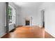 Living room featuring hardwood floors, fireplace and large window with natural light at 1038 E 4Th Ave, Denver, CO 80218